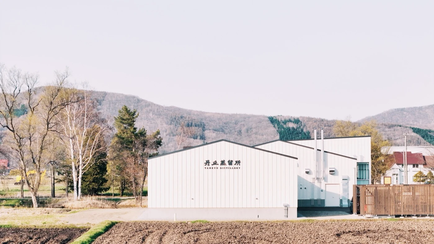 Tankyu Distillery in Higashikawa, with the Hokkaido mountains in the distance.