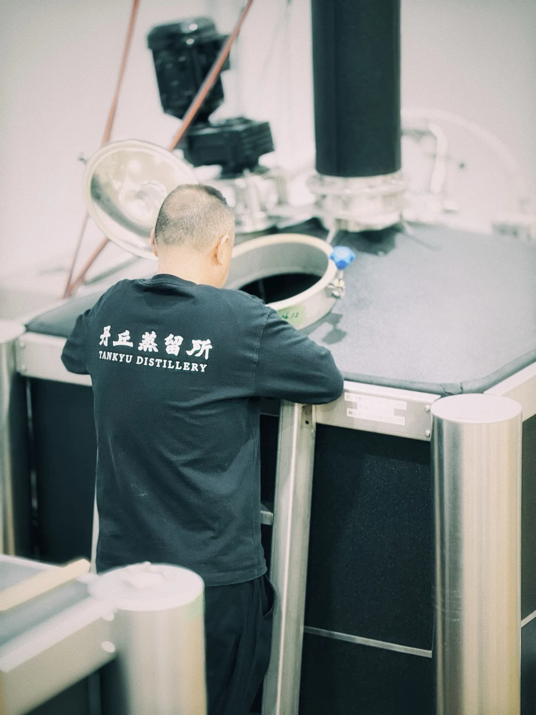 A distiller working at the iStill inside Tankyu Distillery in Hokkaido.