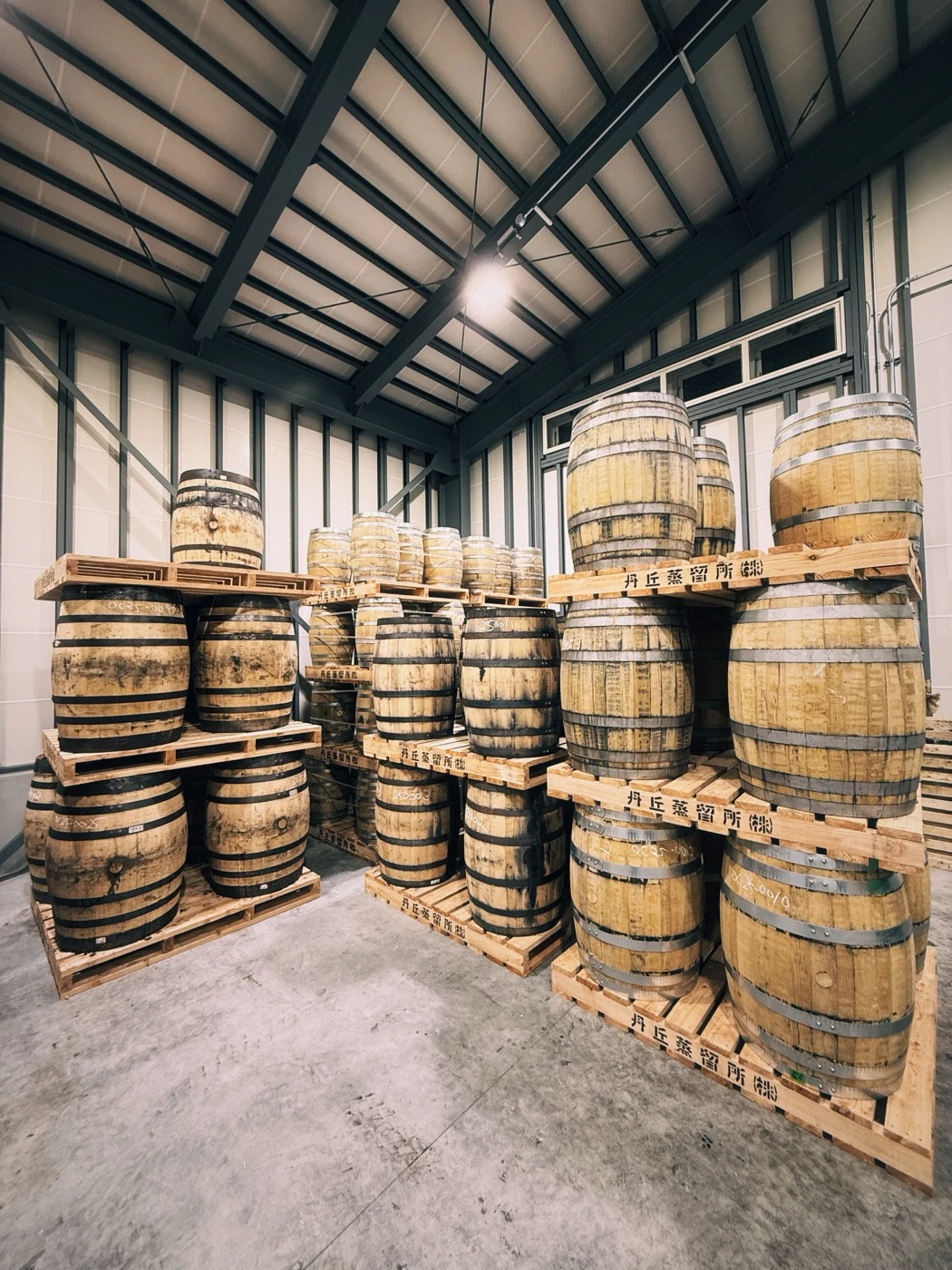 Casks stacked inside Tankyu’s whisky warehouse.