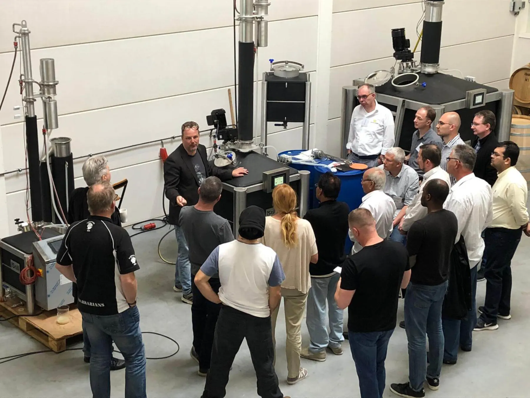 Students gathered around iStill equipment during an on-site distilling course.