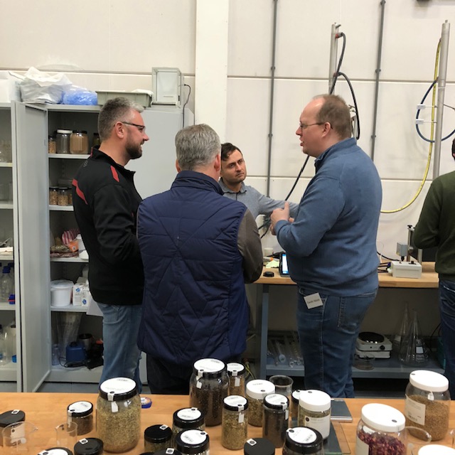 Students compare their ideas while developing gin recipes.